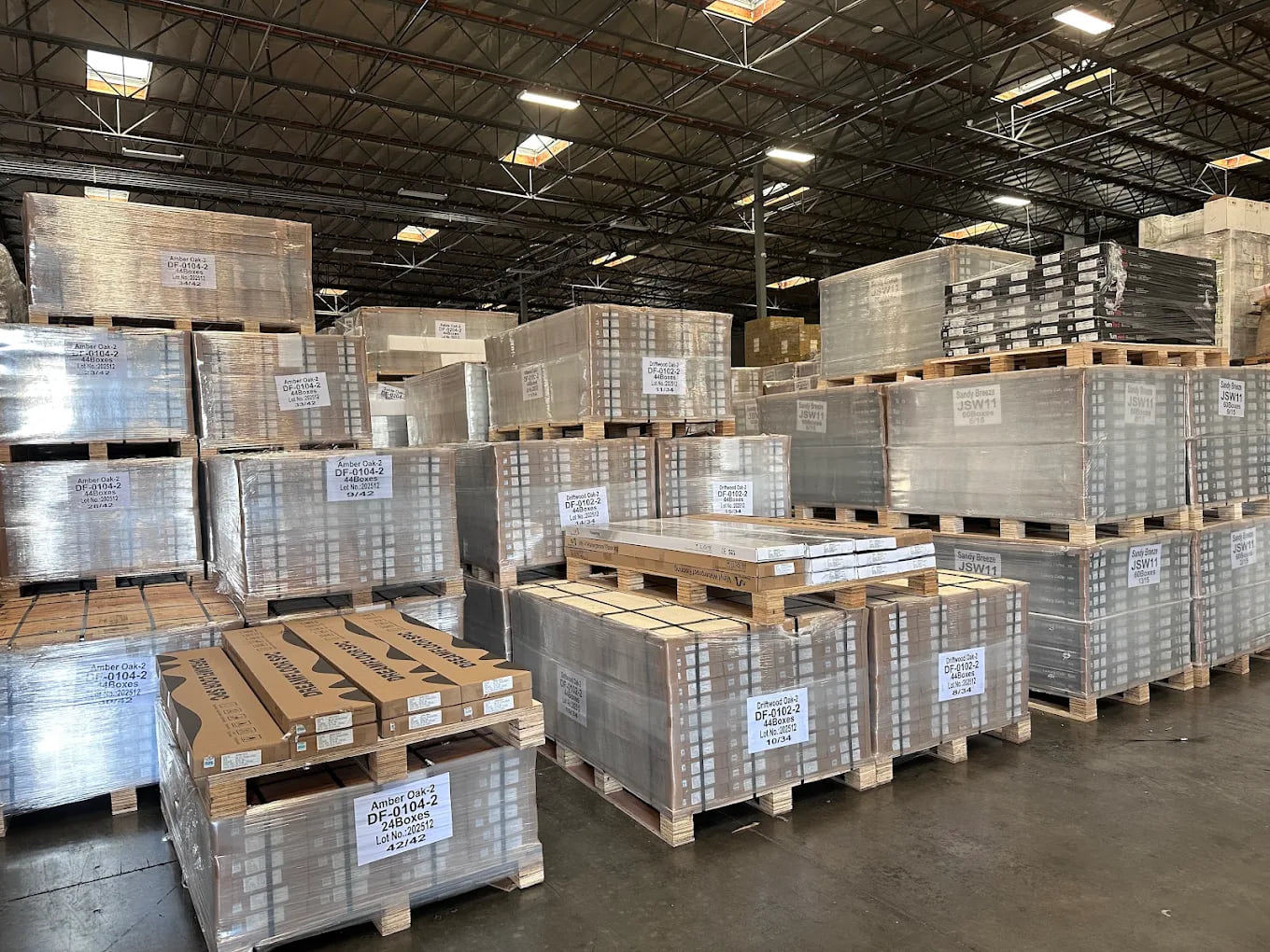 Wrapped SPC flooring pallets arranged inside the Dream Floor warehouse